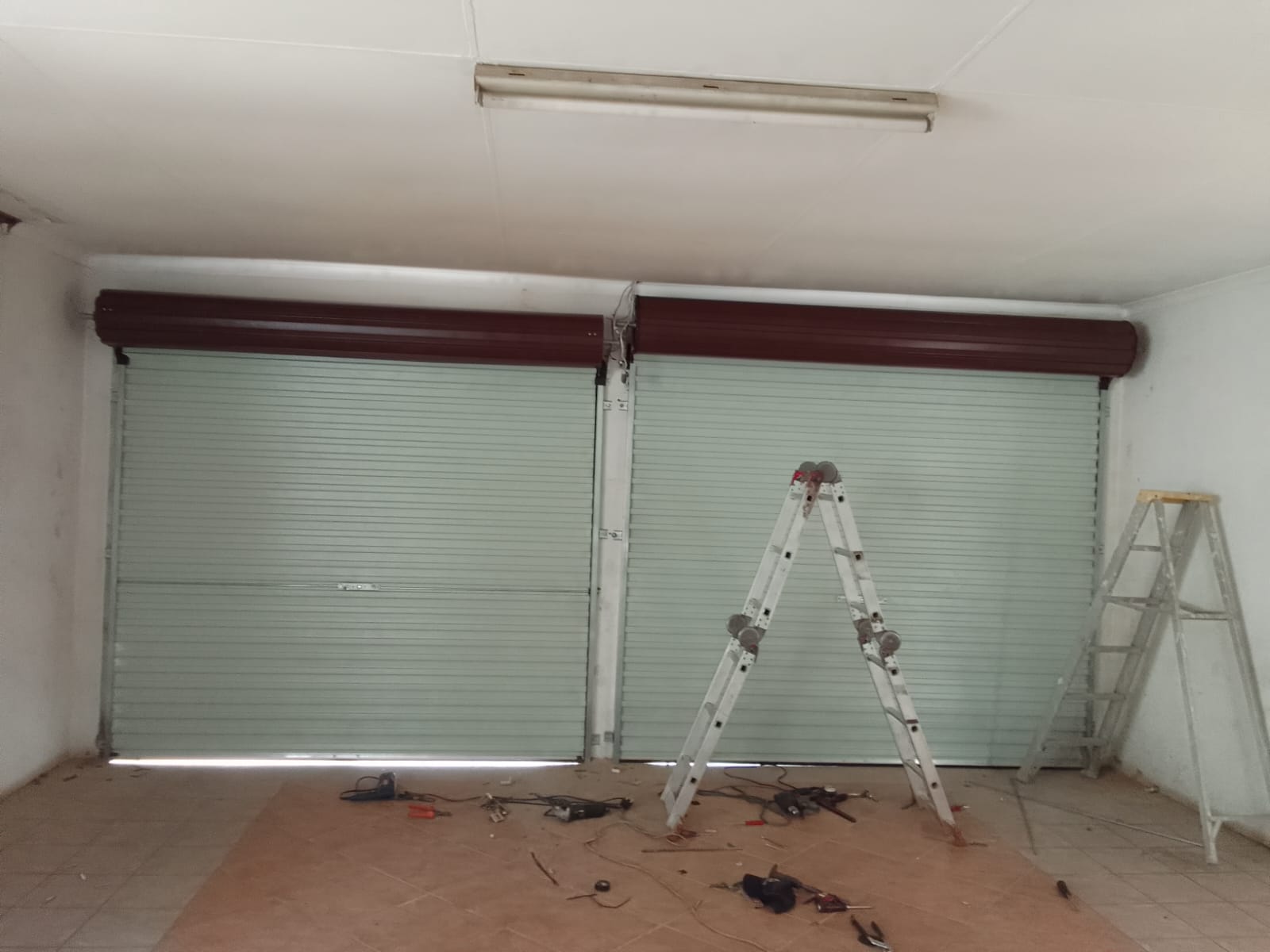 Roll-up garage doors installation in progress