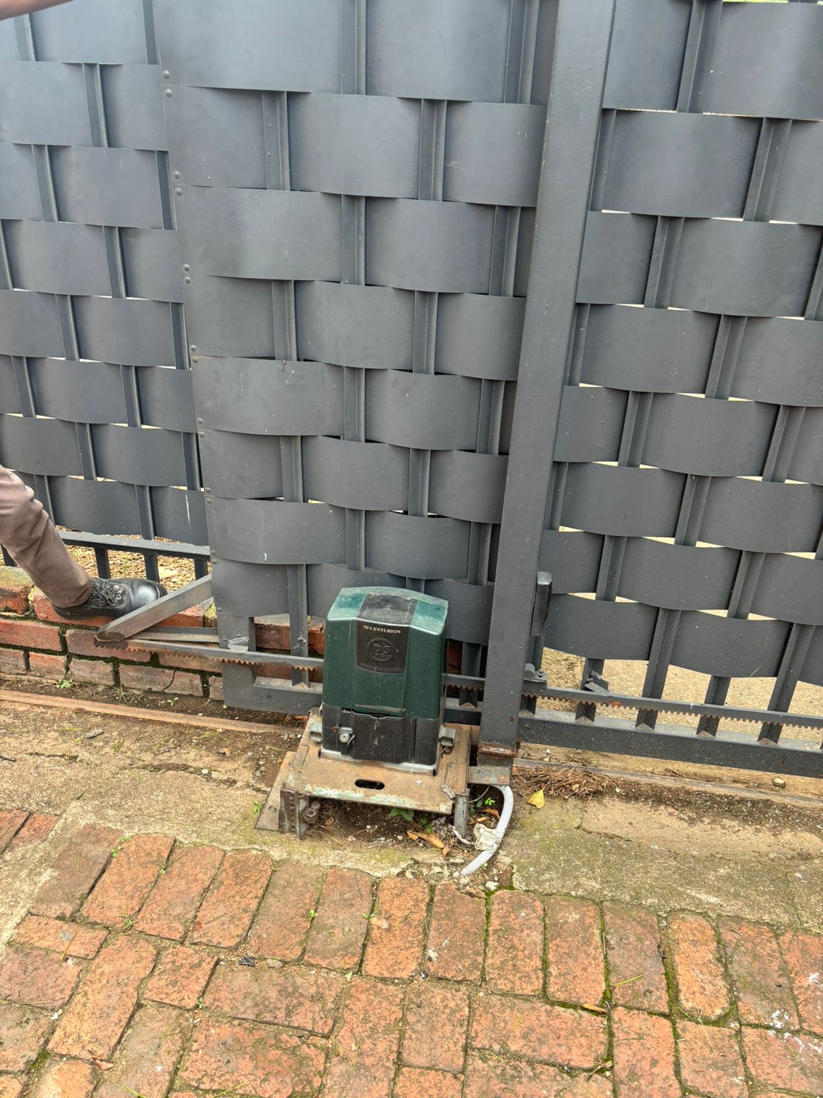 Centurion sliding gate motor on woven gate